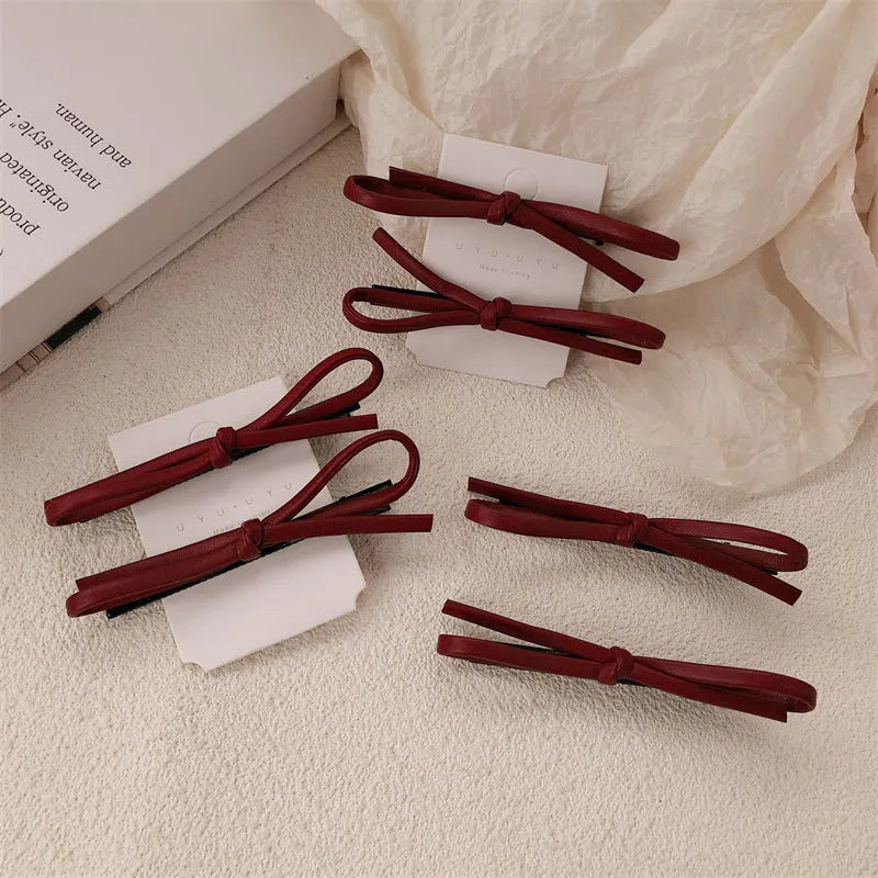 Wine red leather bow hair barrette showing handmade bow design detail
