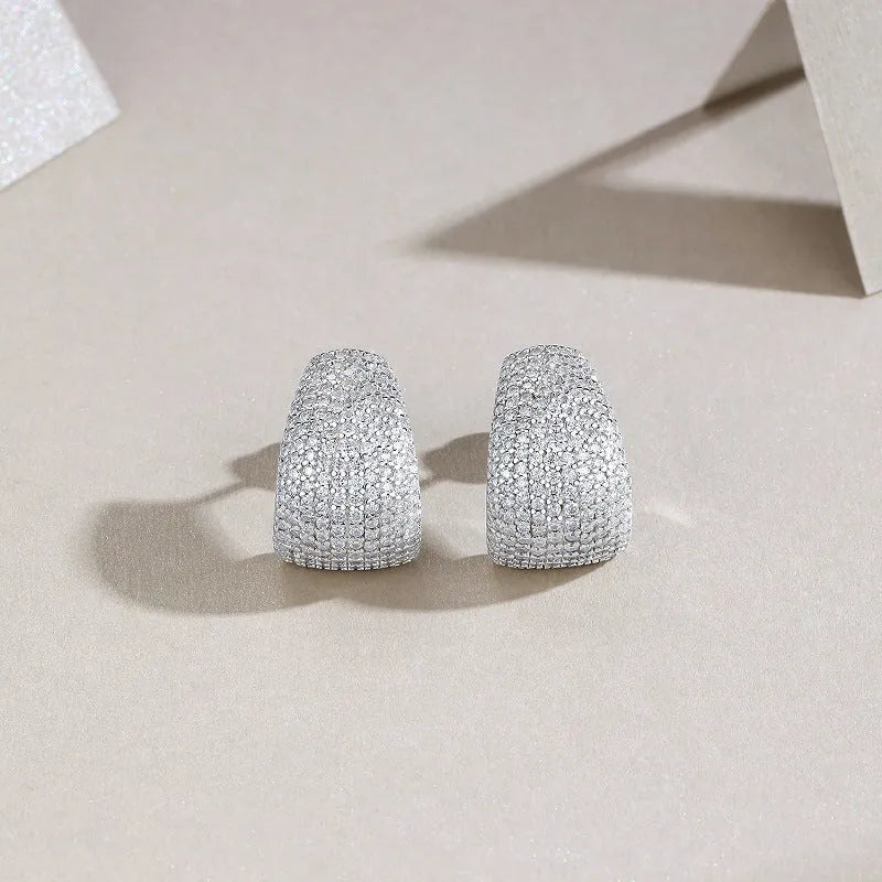 Geometric S925 sterling silver stud earrings with white moissanite stones on a gift box.