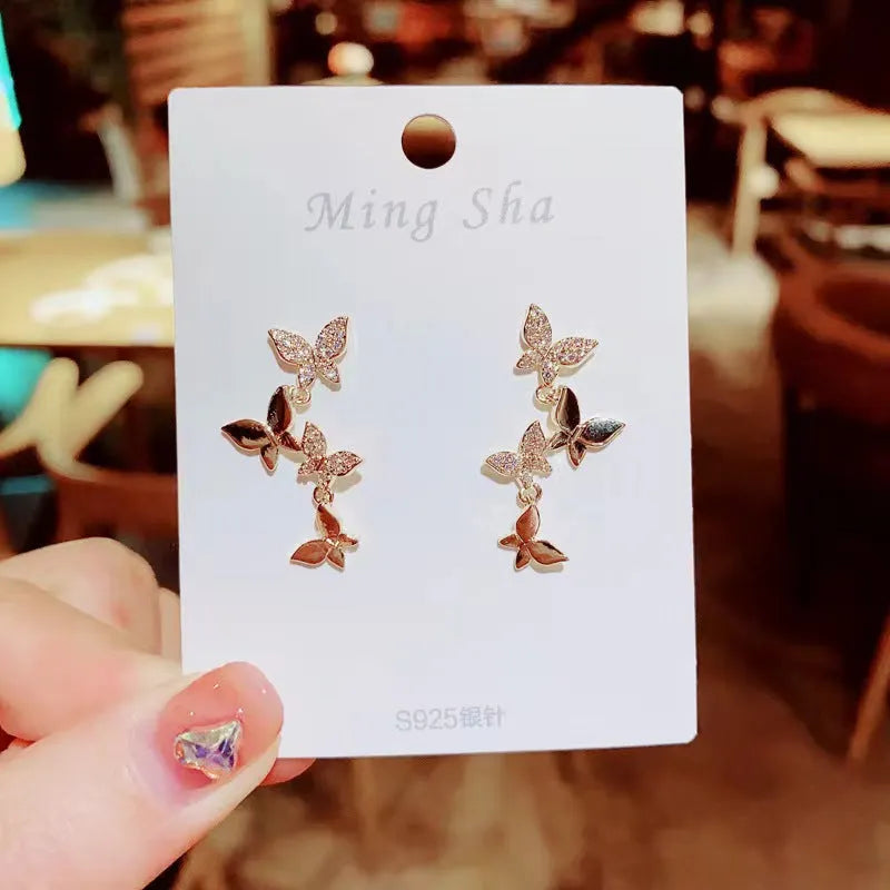Gold-toned copper butterfly drop earrings with four-butterfly design for women