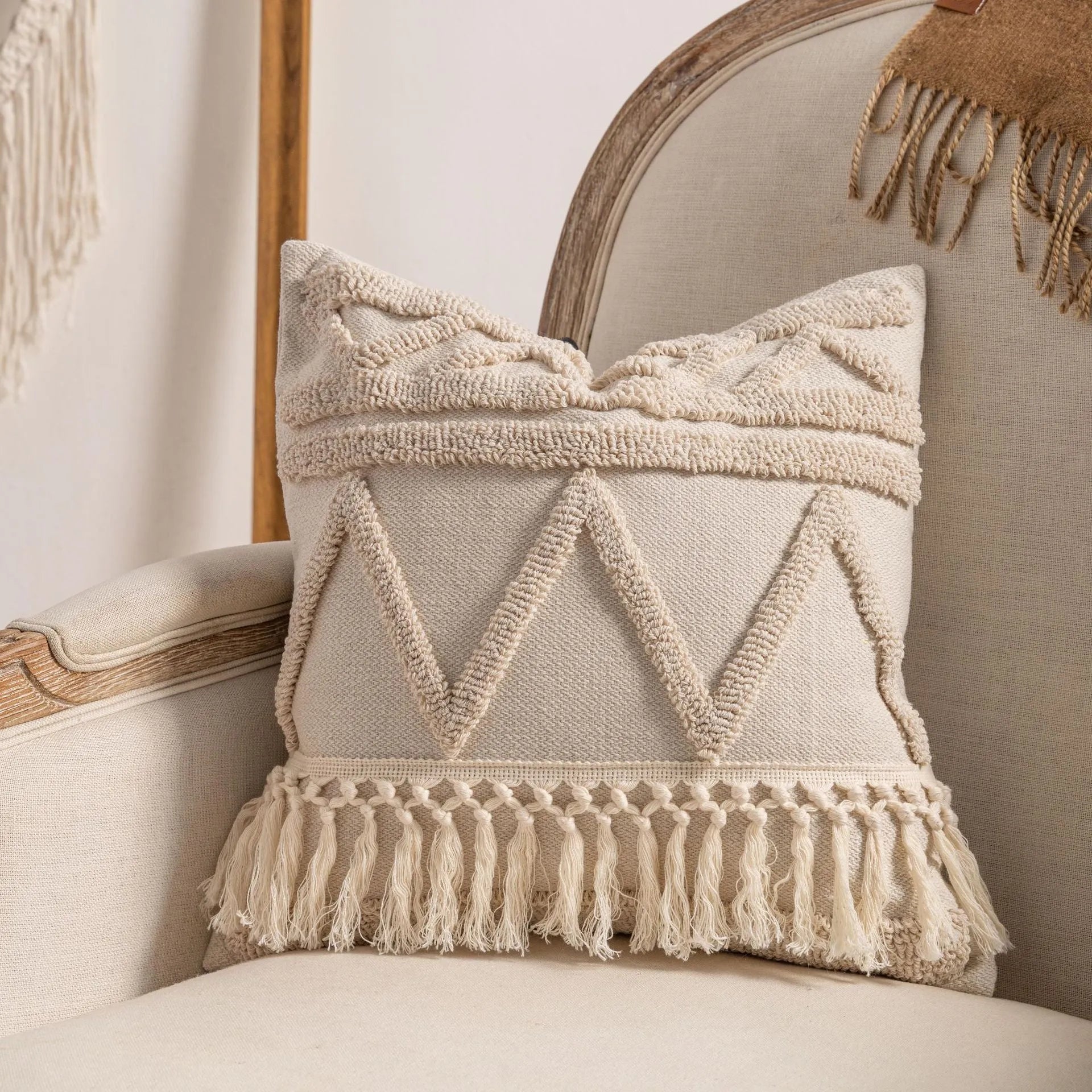 Knitted striped cushion cover with tassel trim in 45x45cm size on a sofa.