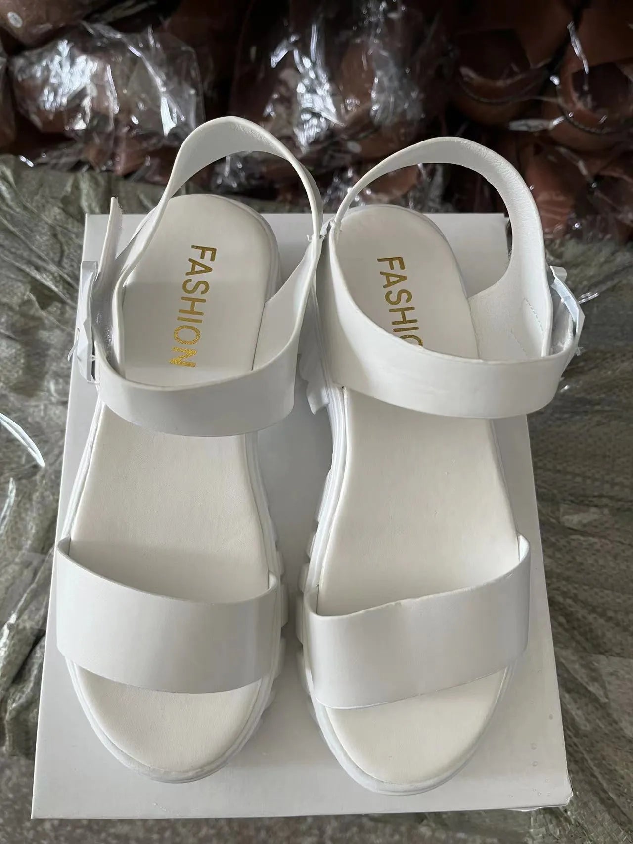 Women's beige peep toe platform sandals with ankle-strap buckle on foot