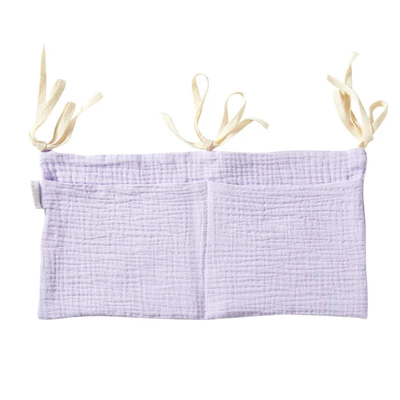 Cotton double layer baby bedside buggy bag in camel colour with tie straps attached to a pram handle