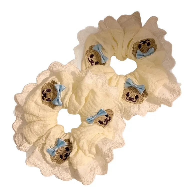 Blue bear bow and lace cloth hair ring with large intestine design on dark background