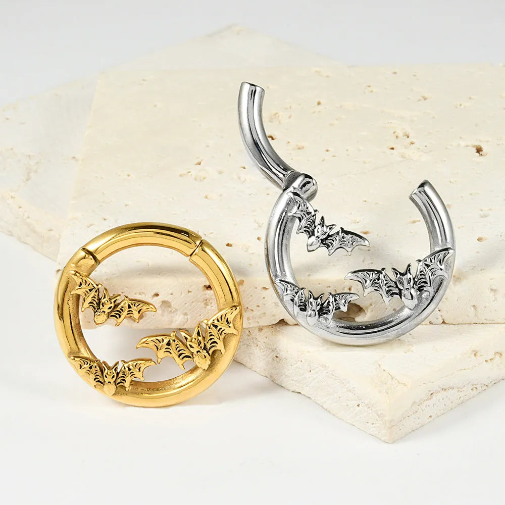 A pair of stainless steel totem pattern earrings with an electroplated finish, shown from the 15 available style options.