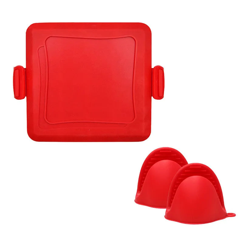 Red silicone baking tray and oven gloves set on a kitchen counter.
