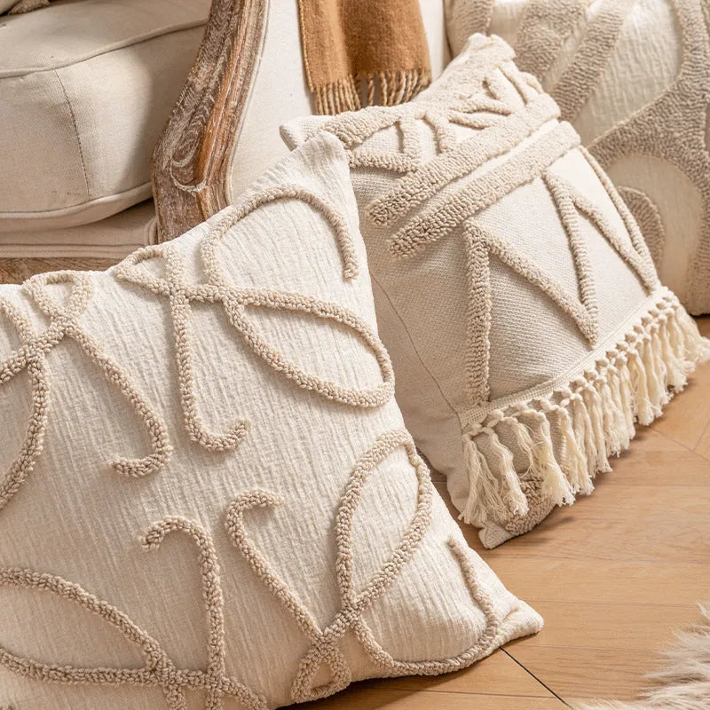 Knitted striped cushion cover with tassel trim in 45x45cm size on a sofa.