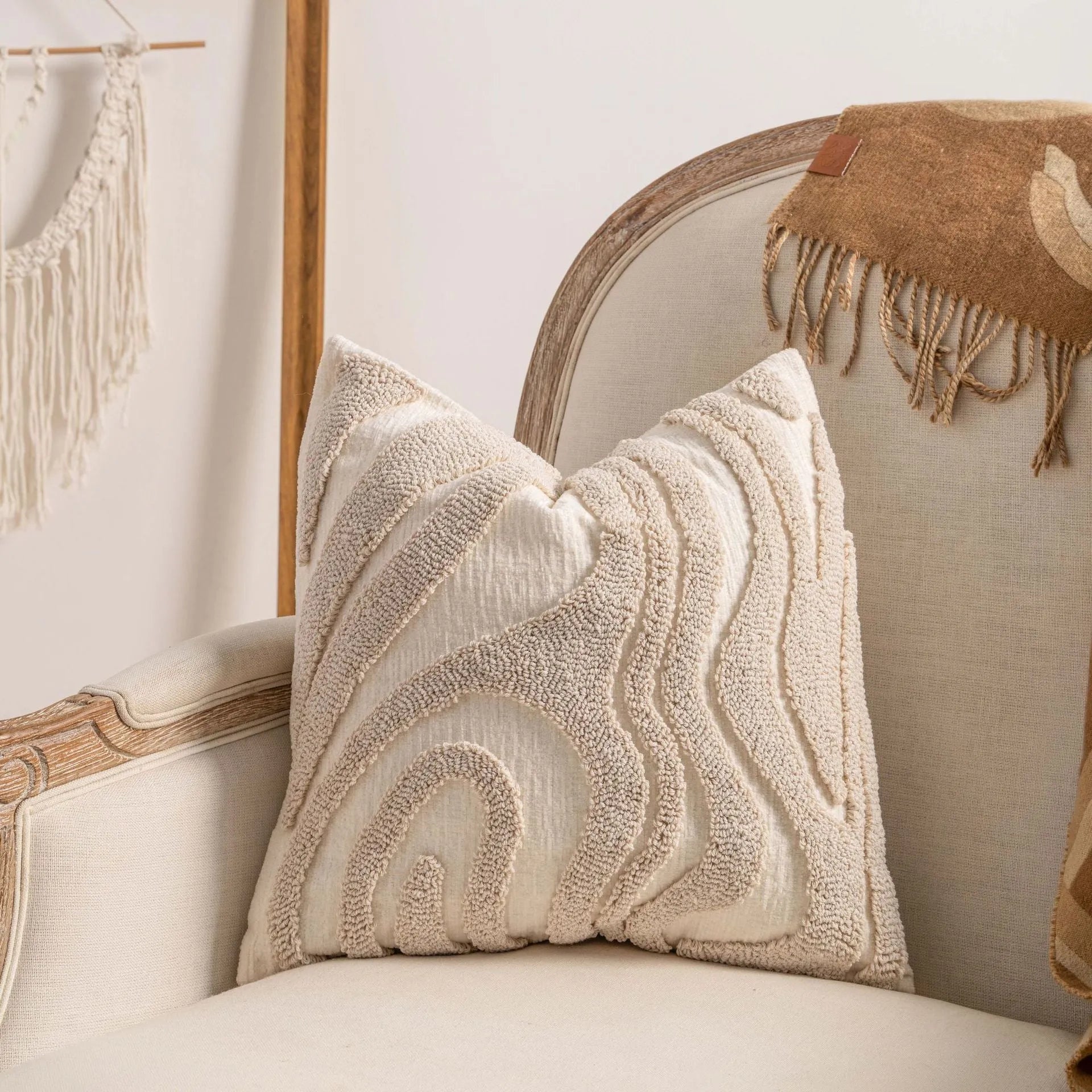 Knitted striped cushion cover with tassel trim in 45x45cm size on a sofa.