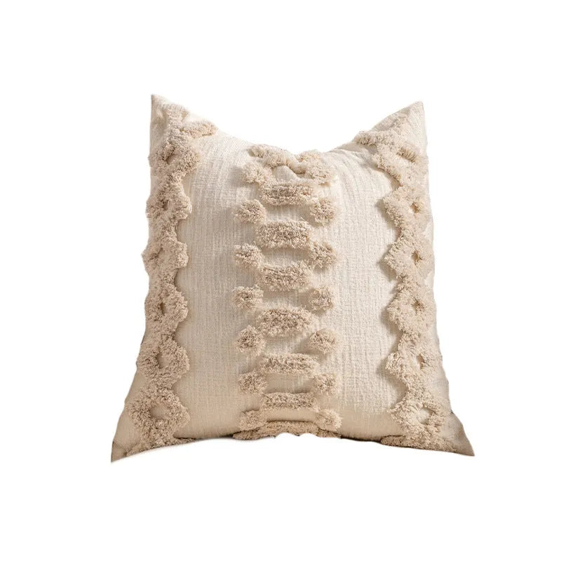 Knitted striped cushion cover with tassel trim in 45x45cm size on a sofa.