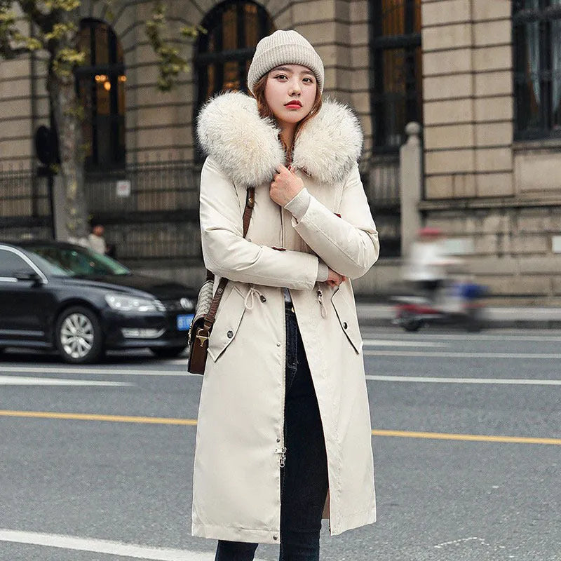 Long beige women's trench coat with cotton-padded fleece construction on a hanger.