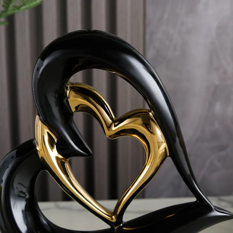 Modern white porcelain heart ornament in a metallic finish, showing its geometric shape on a table.