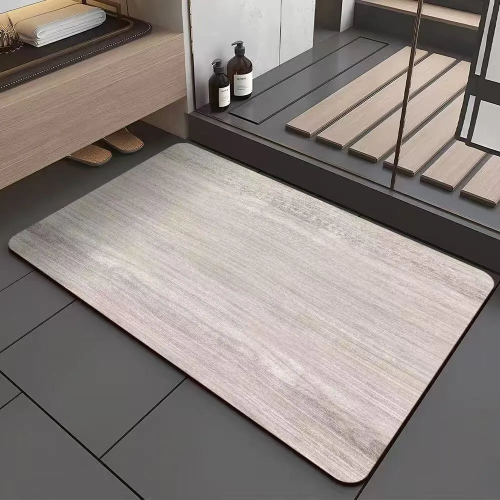Square diatomite bathroom floor mat with wood grain geometric pattern in a bathroom setting.