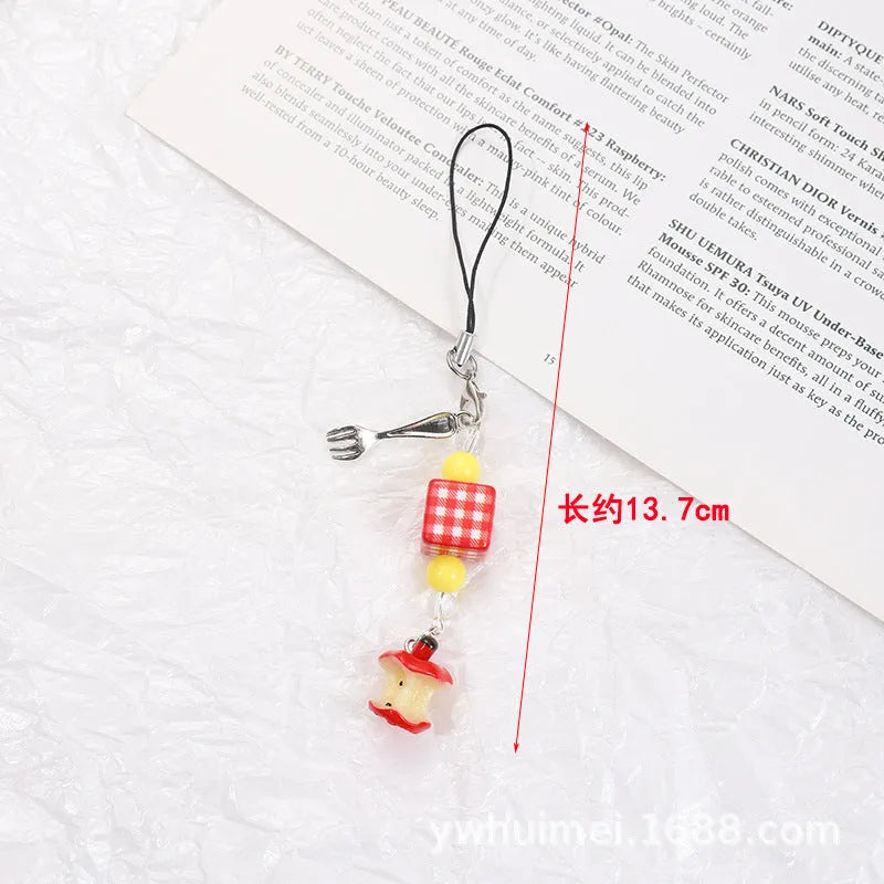 Plastic resin fruit phone charm keychain with strawberry design on white rope cord