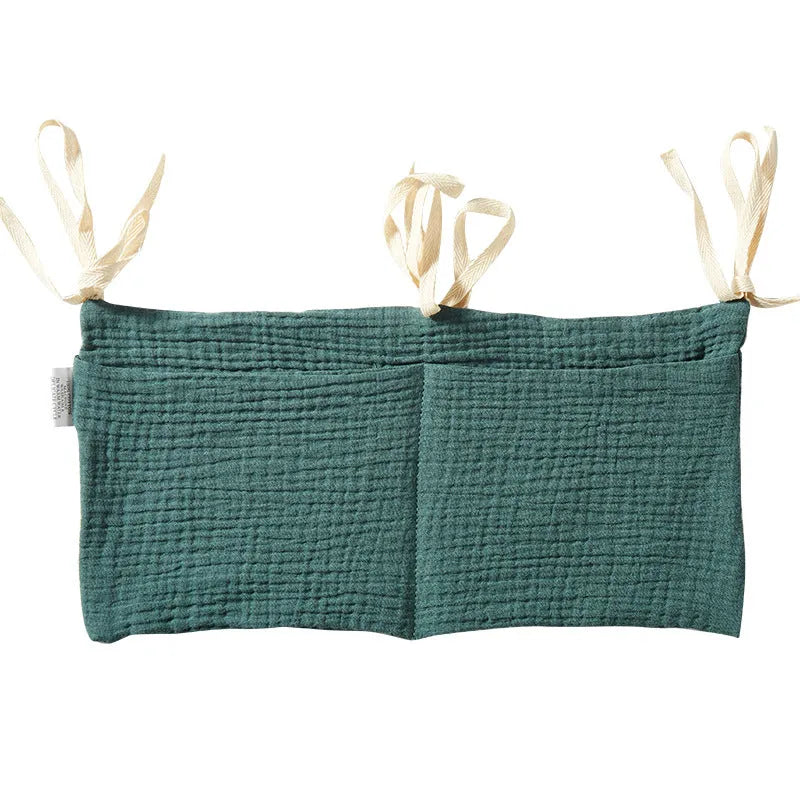 Cotton double layer baby bedside buggy bag in camel colour with tie straps attached to a pram handle