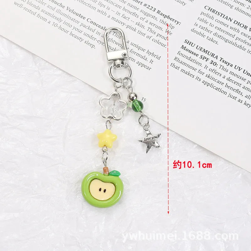 Plastic resin fruit phone charm keychain with strawberry design on white rope cord