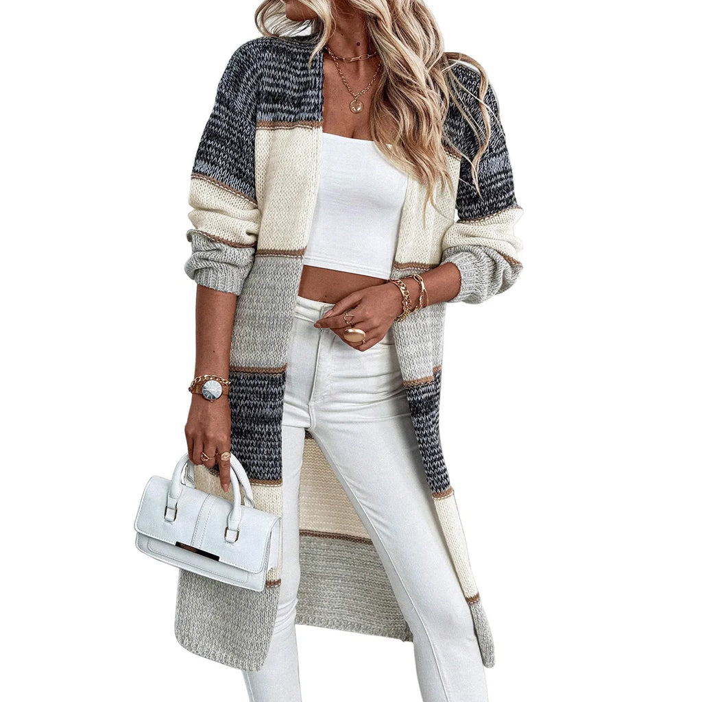 Grey knitted long cardigan with loose fit and long sleeves on a woman