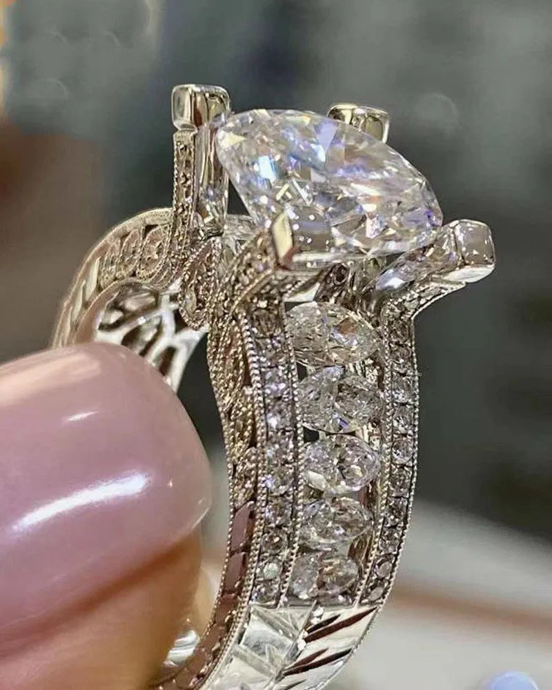 Geometric silver-toned women's fashion ring in gold or white colour on a grey background.