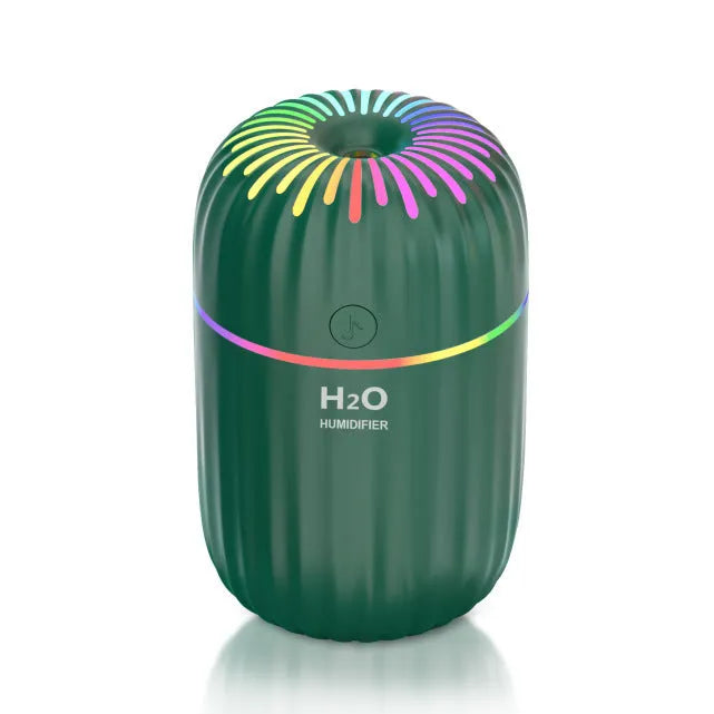 Compact green animal-shaped USB humidifier and aromatherapy diffuser on a desktop