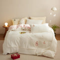 Milk fibre bedding four-piece set with green Christmas tree pattern on duvet cover, sheet, and pillowcases.