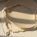 Gold baroque pearl clavicle chain necklace with copper pendant on a woman's collarbone