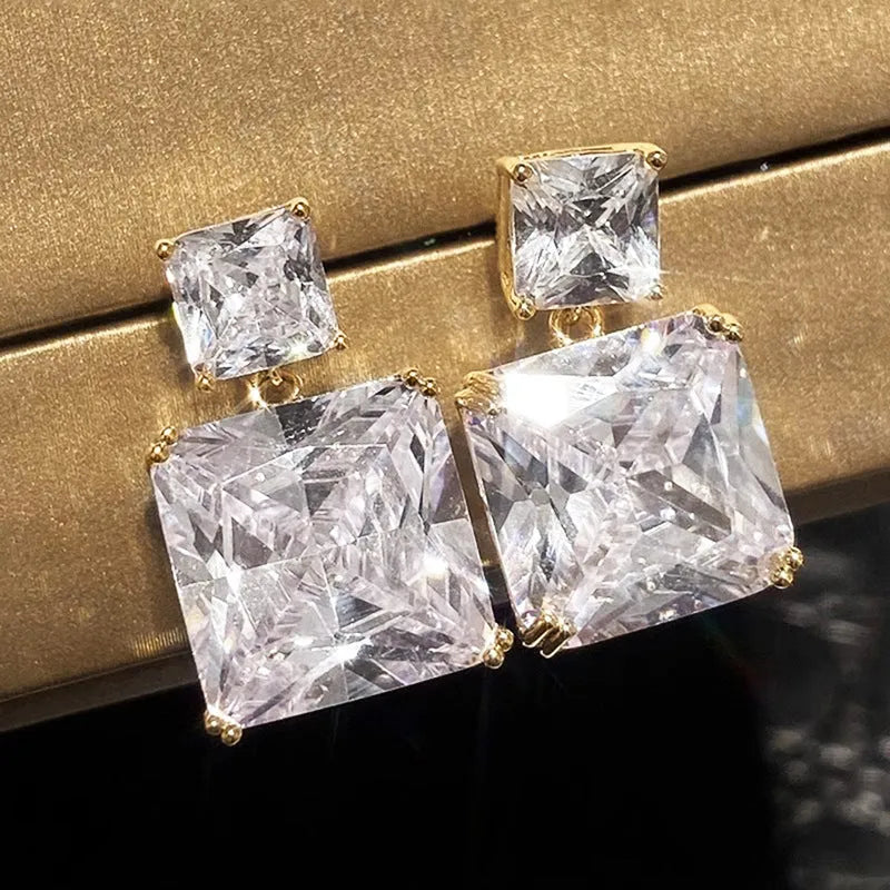 A pair of copper geometric square earrings for women, shown in white gold and golden colour options.