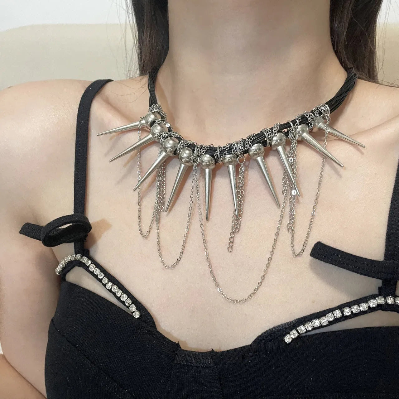 Women's casual leather necklace with electroplated round beads, rivet detailing, and winding tassel design