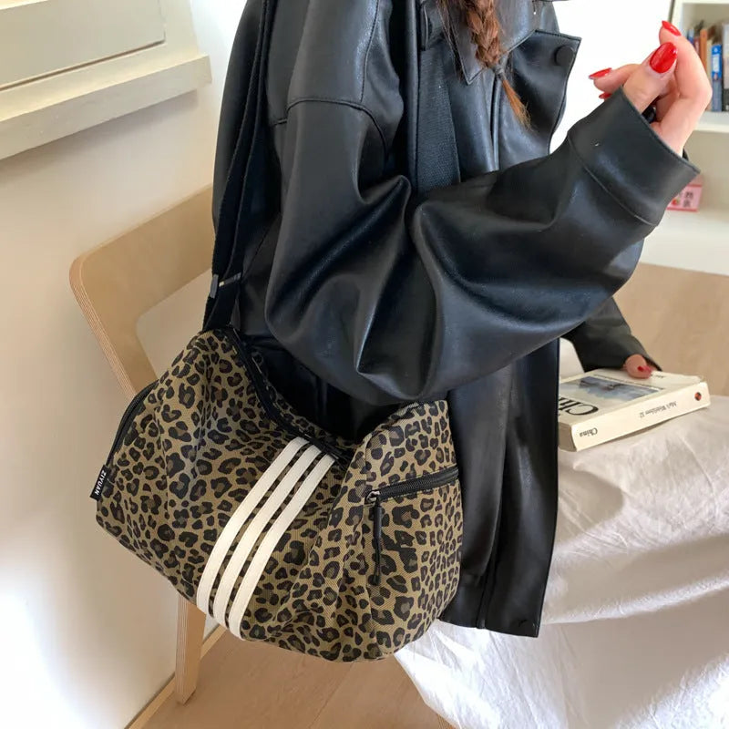 Sports style shoulder messenger bag in leopard print or stripes pattern with crossbody strap
