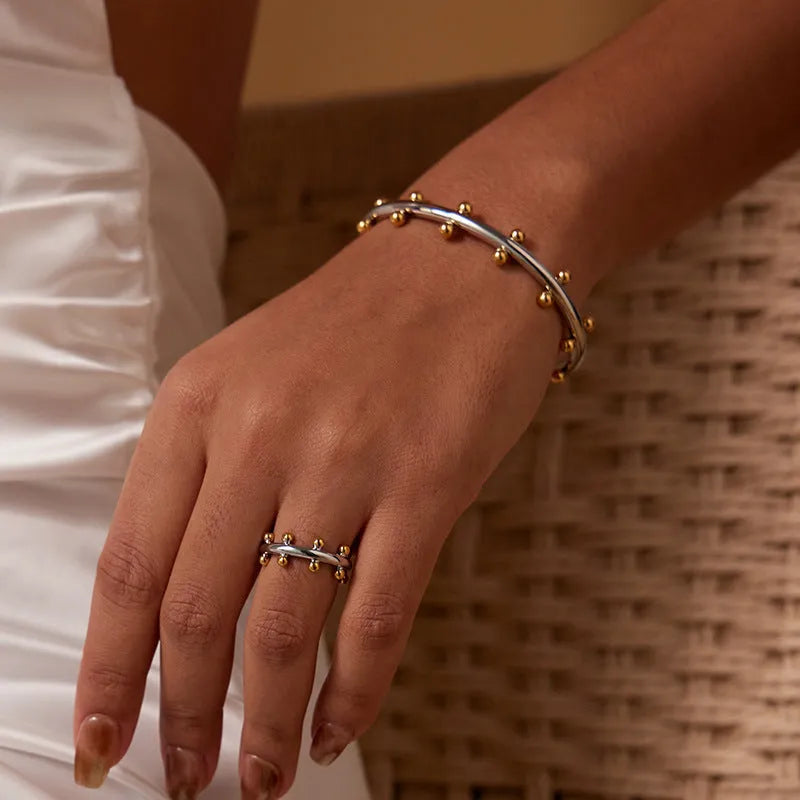 Stainless steel C-shaped bracelet with rivet-shaped bean beads and adjustable alloy chain in steel gold colour