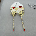 Gold exaggerated insect asymmetric earrings for women on white background with hook fastening