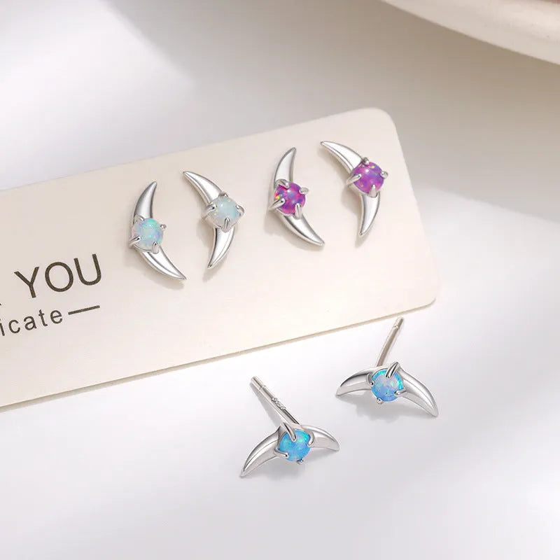 Geometric women's earrings in 925 silver with gold or platinum finish and blue, purple, or white stone.