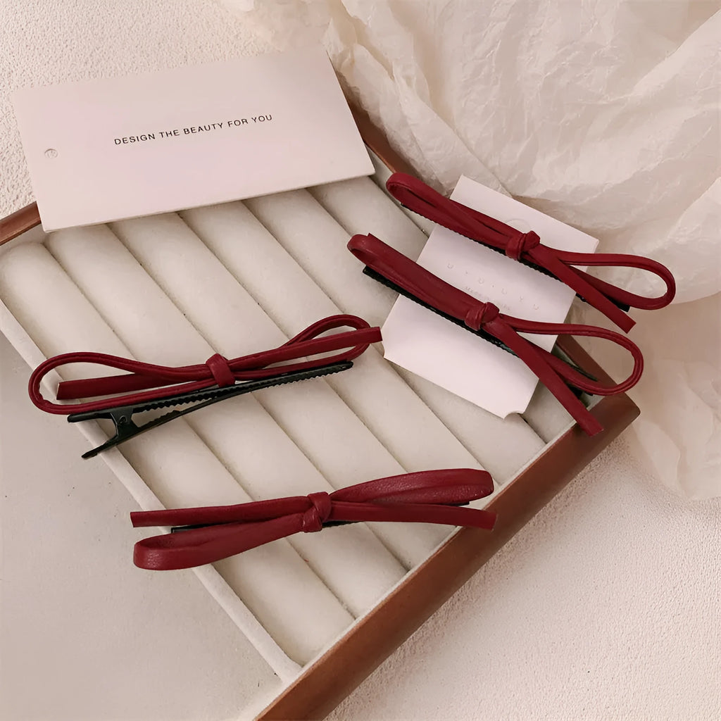 Wine red leather bow hair barrette showing handmade bow design detail