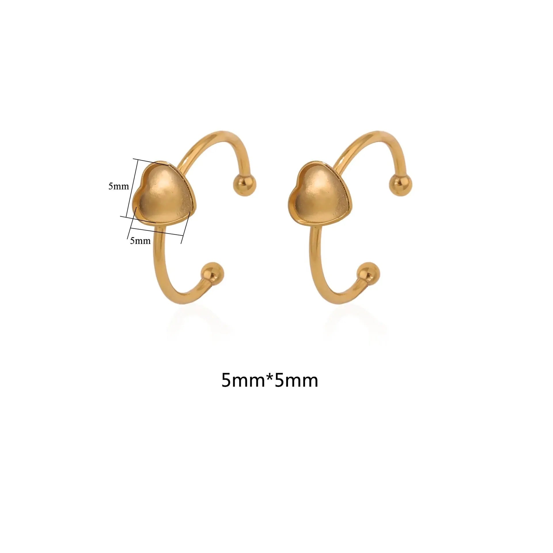 Assortment of golden stainless steel DIY jewellery settings in oval, heart, round, square, and rectangle shapes with totem pattern.