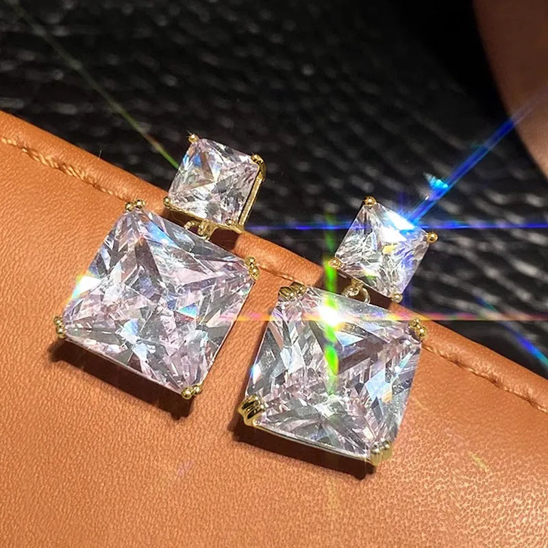 A pair of copper geometric square earrings for women, shown in white gold and golden colour options.