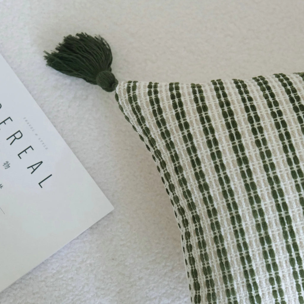 Green botanical pattern hotel sample pillow with tassel detail on linen cotton cover