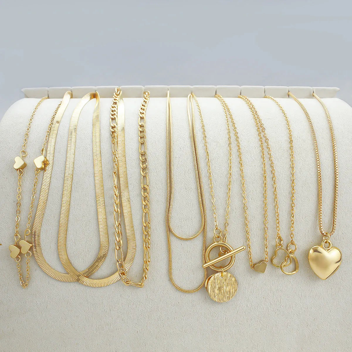 Gold necklace set with ten alloy pendants on adjustable snake bone chain