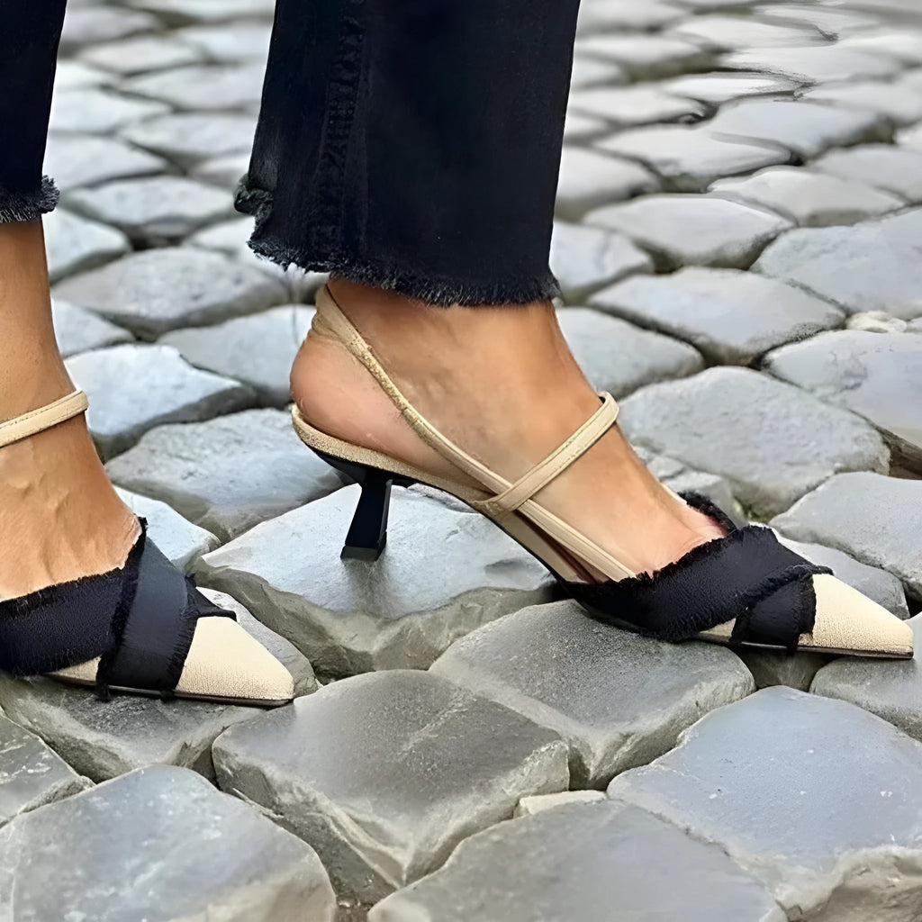 Women's apricot and black colour block stiletto heel sandals with a buckle fastening and pointed toe.