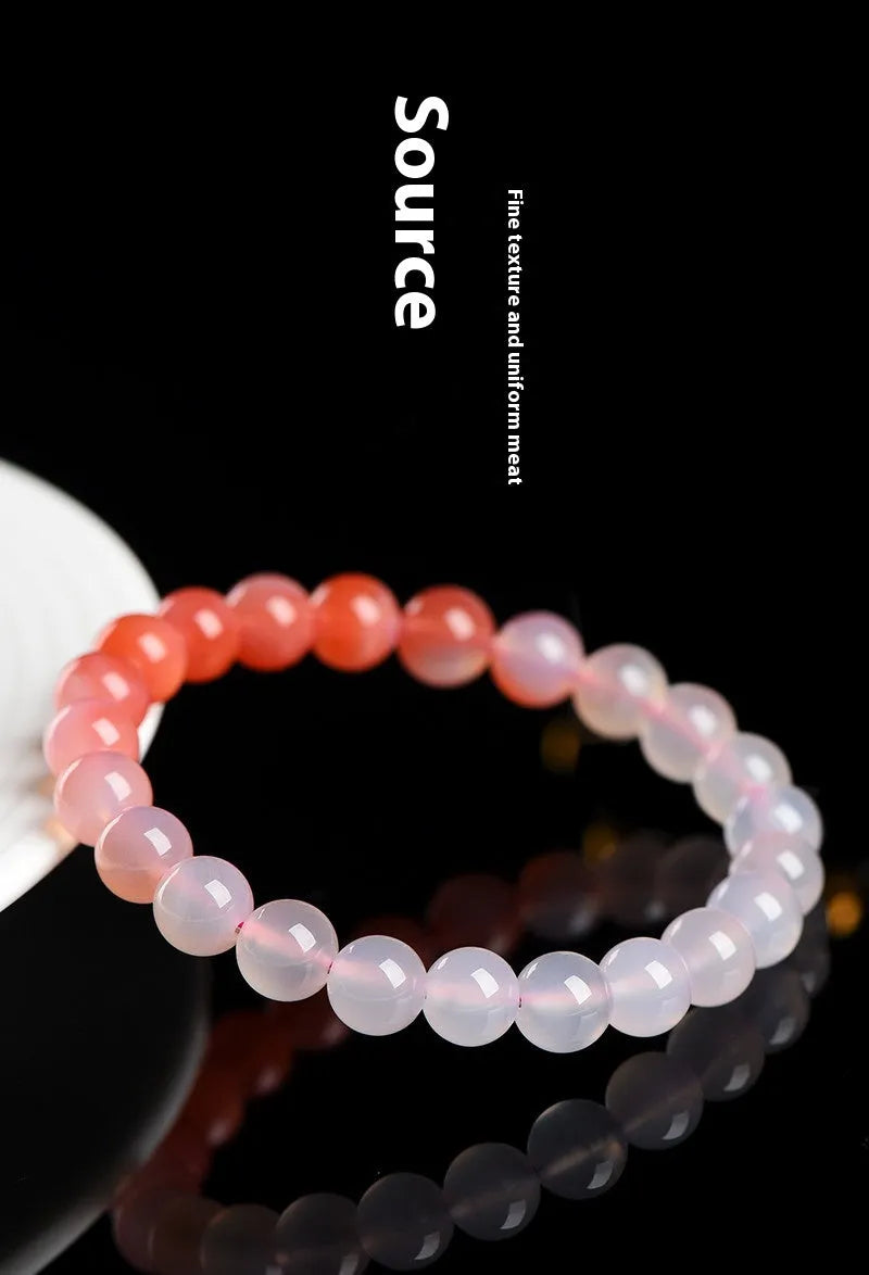 Natural gradient Yanyuan agate beaded bracelet with geometric polished beads on a wrist.