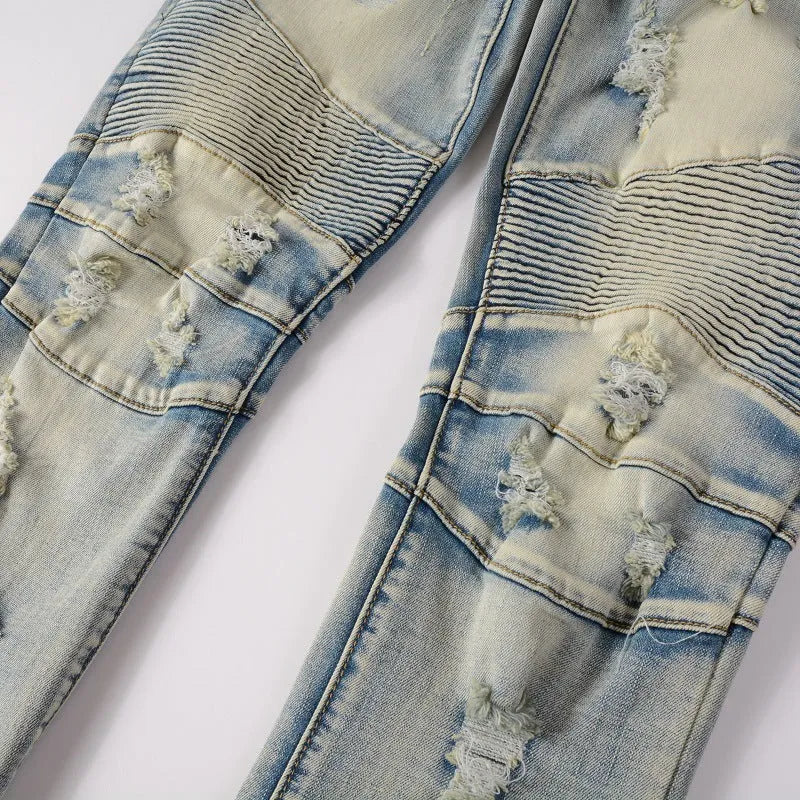 Light blue men's slim fit distressed jeans with hand-frayed detailing and a tapered leg.