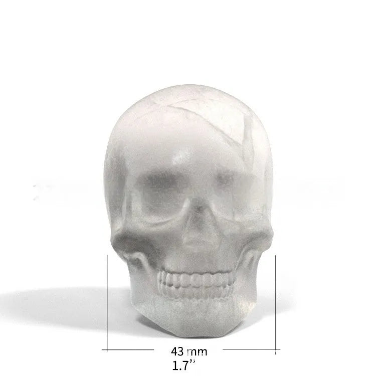White silicone Halloween ice cube tray with detailed 3D skull mould cavities.