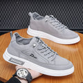 Grey men's canvas casual shoes with leather lining and rubber sole showing stitching details