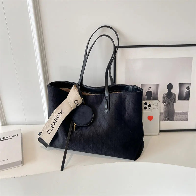 Large casual tote bag with shoulder strap in horizontal square shape with zippered internal compartment