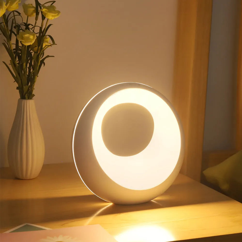 Creative Touch small white RGB colour changing night lamp with remote control on a wooden desk.