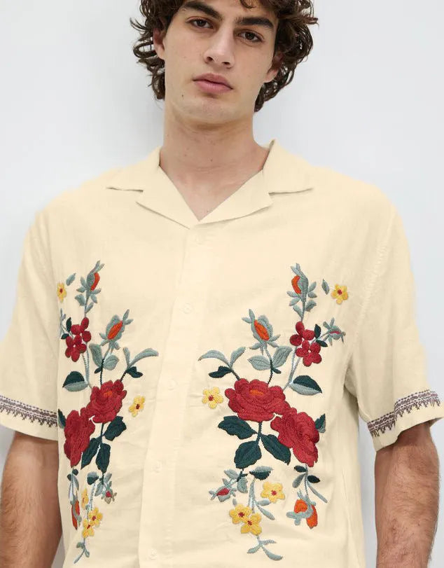 Apricot-coloured men's casual shirt with vintage floral print, short sleeves, and a cardigan-style lapel.