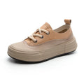 Women's leather platform sneakers in matcha green, side view showing round toe and lace-up design.