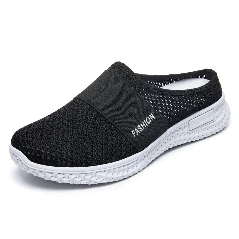 Women's black mesh casual flat shoe with round toe and hollow-out design on a neutral background.