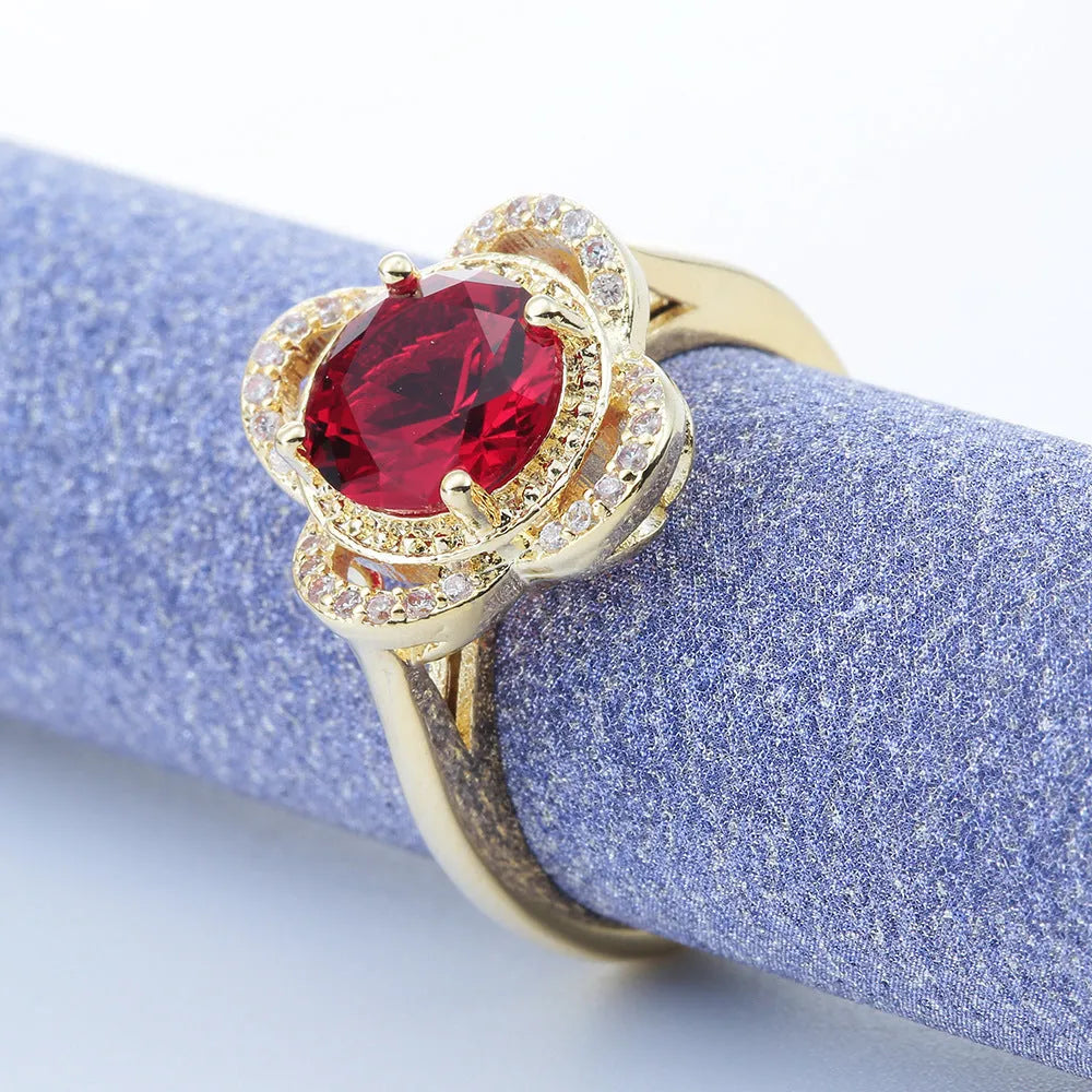 Copper zircon ring with a fruit-shaped design on a finger.