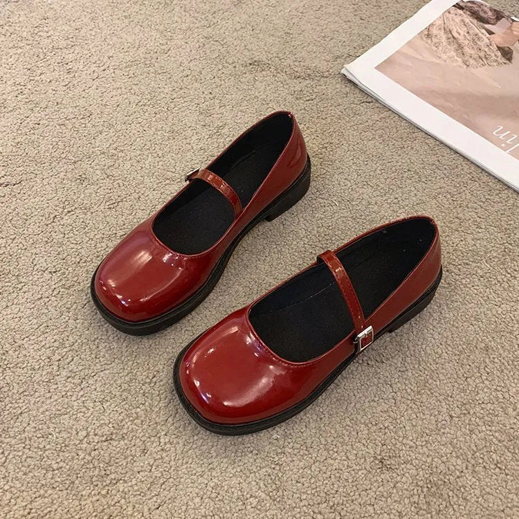 Women's solid colour flat shoes with round toe in red, black, and grey options