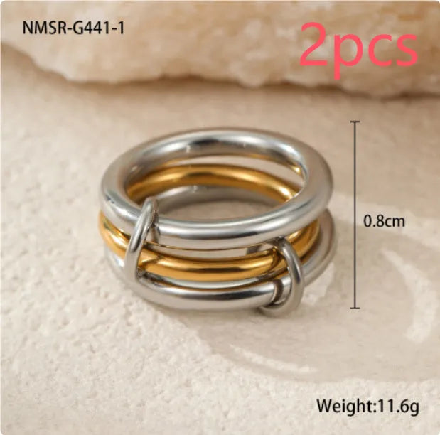Stacked gold plated stainless steel rings showing layered jewellery look on female hand