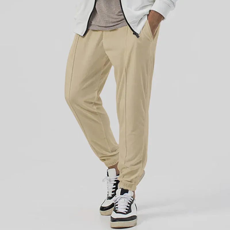Men's loose tapered casual track sweatpants in cotton blend fabric showing straight-leg design