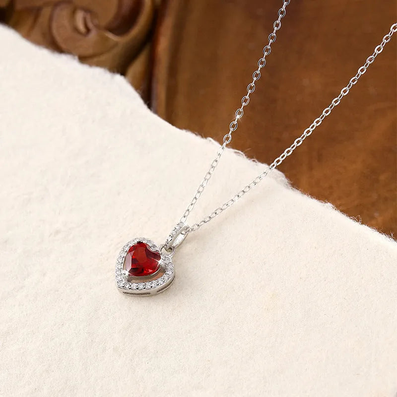 Sterling silver heart pendant necklace with a natural coloured gemstone on an adjustable cross chain.