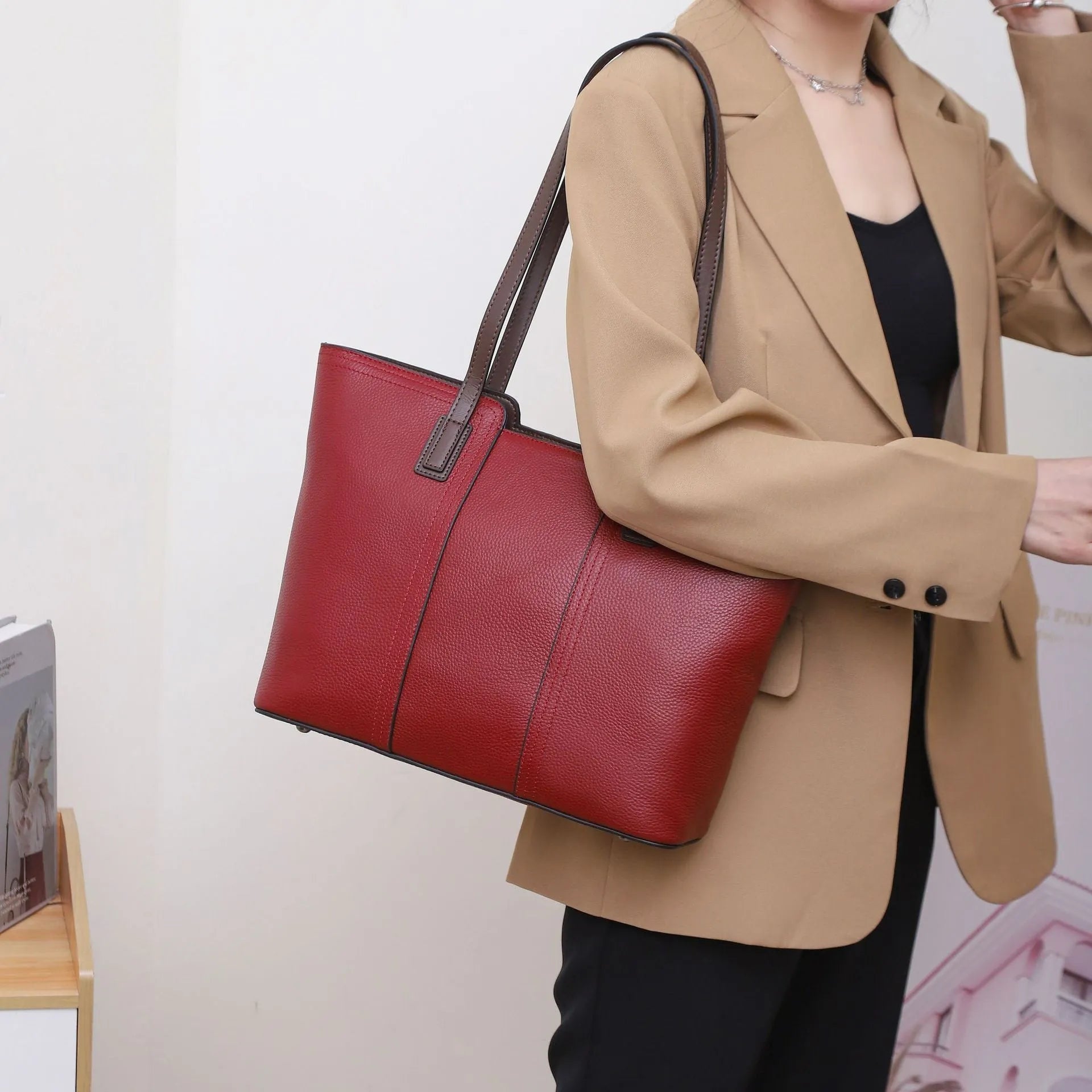 Women's genuine leather shoulder bag in khaki colour showing box-type design and organised interior compartments